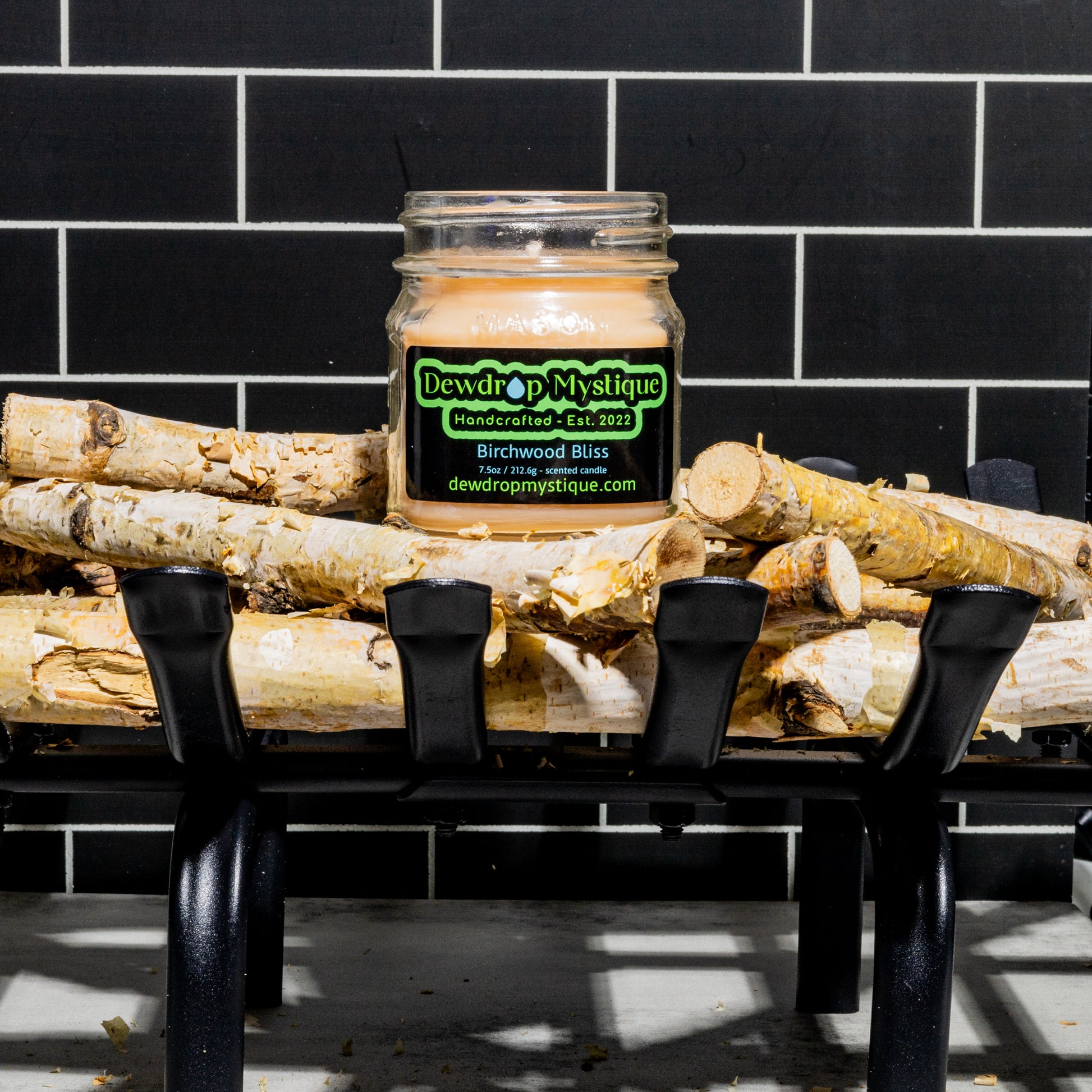 Birchwood candle sitting on top of birchwood sticks.