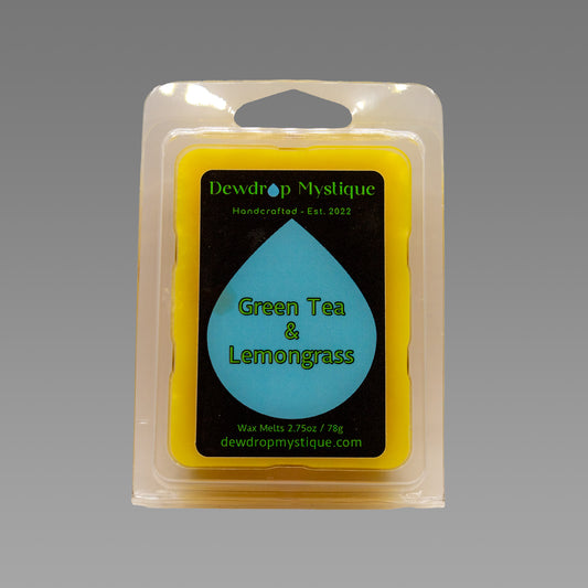 A wax melt pack labeled 'Green Tea & Lemongrass' from Dewdroup Mystique, established 2002.